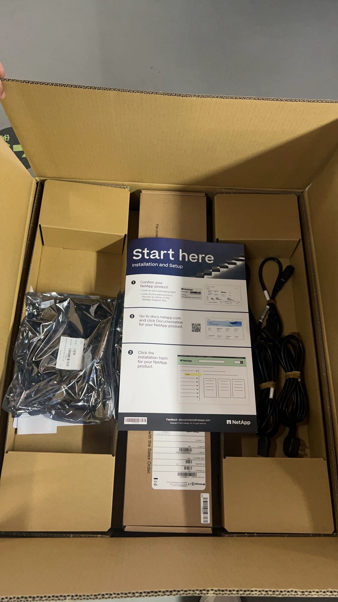 Divided cardboard compartments, setup leaflet, cables and bagged accessories.