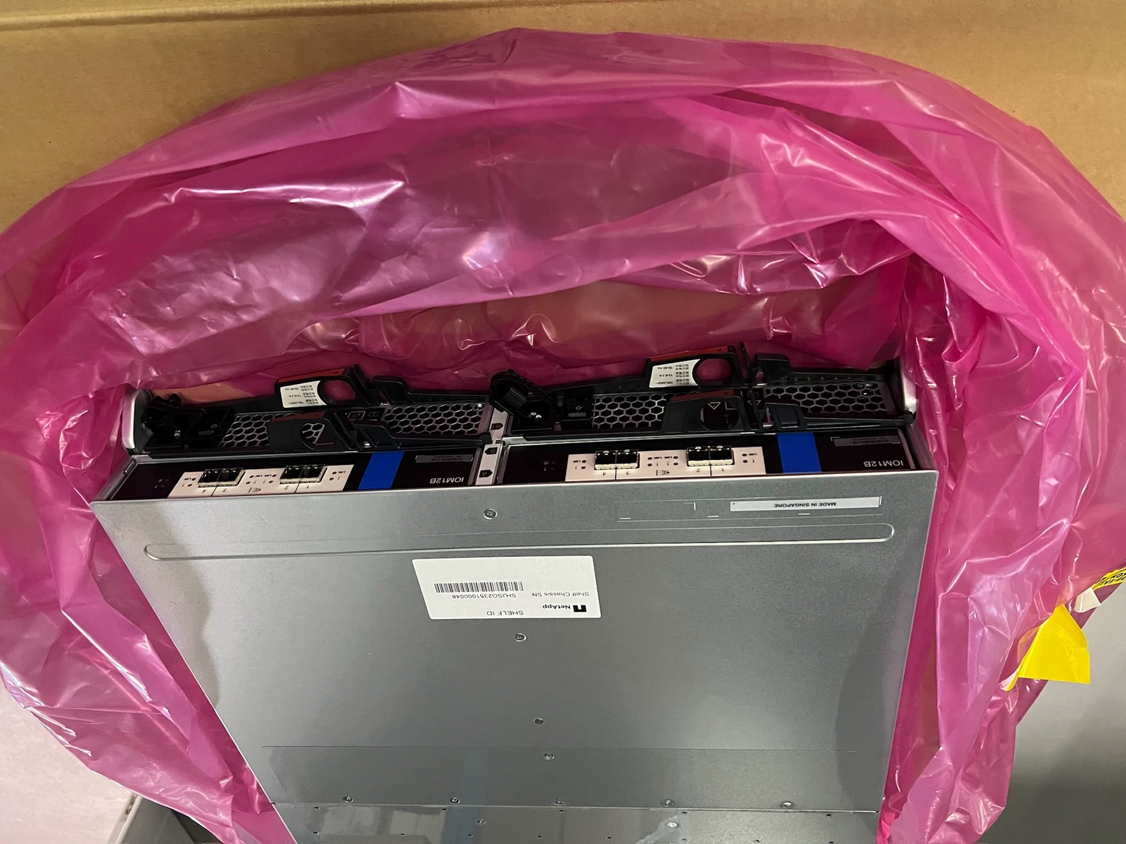 Rear-panel modules, power assemblies and physical labels in the supplied photograph.